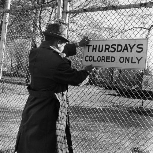 This sign reads, ‘Thursdays — Colored Only.’ In mid-century Memphis, the zoo allowed Black families to visit just one day a week. Here, Withers captures the stark routine of segregation—an everyday notice tacked to a wall. Images like this remind us that injustice was often printed in plain sight, shaping childhood memories, family outings, and the rhythm of ordinary life.