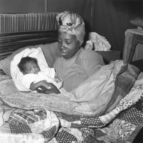 In the late 50's and early 60's, a push was made by the Student Non-Violent Coordinating Committee, and other civil rights organizations, to expand their work outside of urban centers. So called "Freedom Summers" were organized, where town halls, sit-ins, voter registrations drives, and similar activities were organized. As a response to this, the white residents of Fayette and Sumner County (TN) organized a blacklist of African American residents who participated in these events. Those on the list were not allowed to, among many other things, get much needed loans from banks to finance their farmwork. This eventually forced them off their land, and many took up residence in the "Freedom Village" tent city on farmer Shepard Towles' land. Here we see the first baby to be born in Freedom Village.