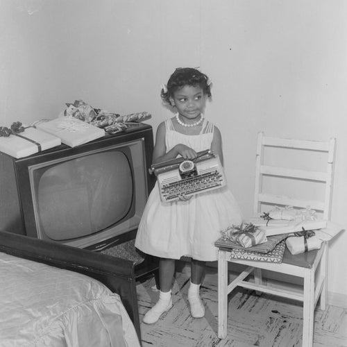 Withers loved capturing everyday life, especially families and children. This young girl with her typewriter is another example of highlighting the simple joys found in Black homes despite the challenges of the time period.
