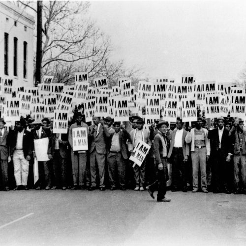 In 1968, Memphis sanitation workers marched carrying signs that read, ‘I AM A MAN.’ Their message was simple but revolutionary — a demand to be seen as human. This photo captured the strikers outside Clayborn temple just before the march began.