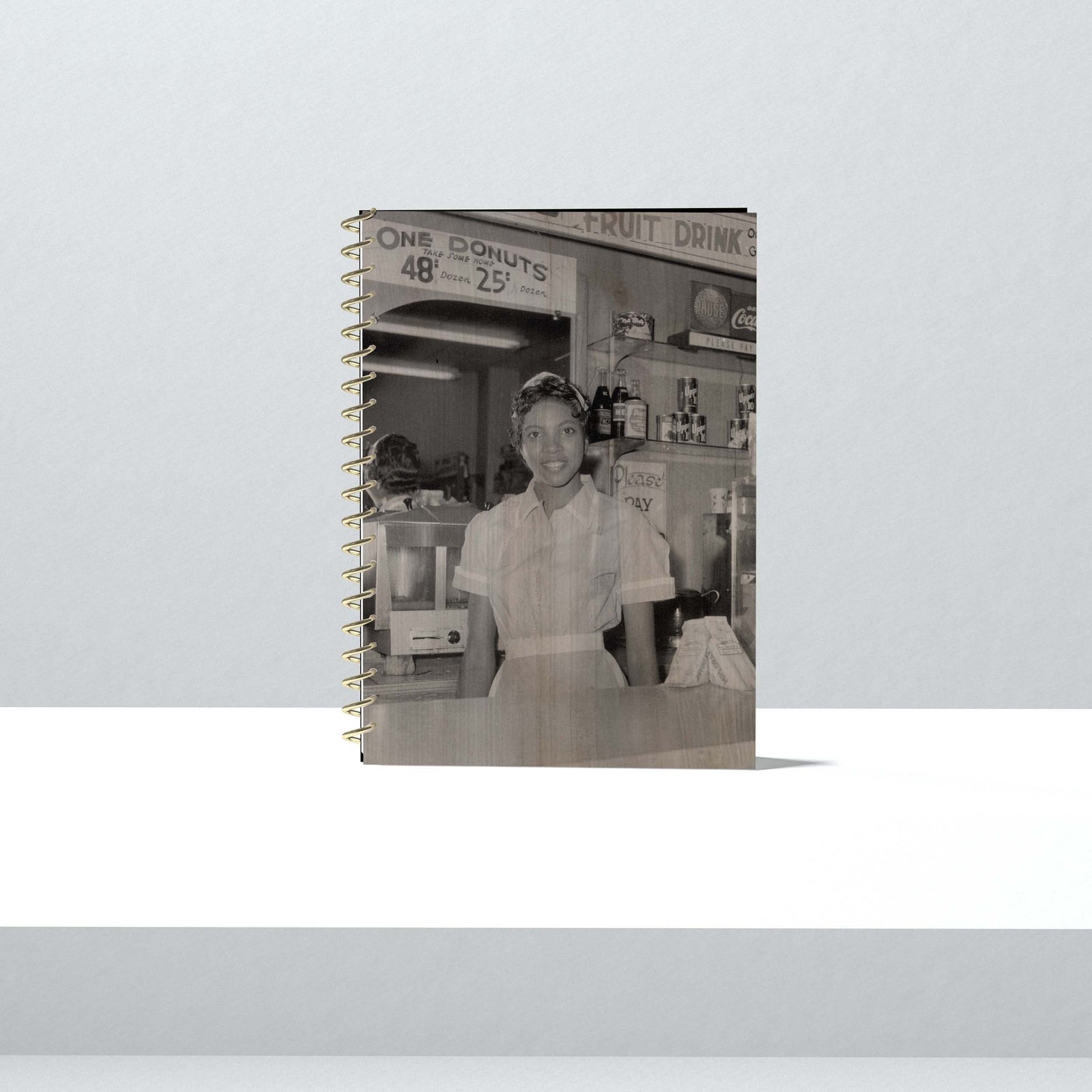 This 1950s photo captures Helen Ann Smith as she poses at the counter of the Harlem House diner, a restaurant chain based ...