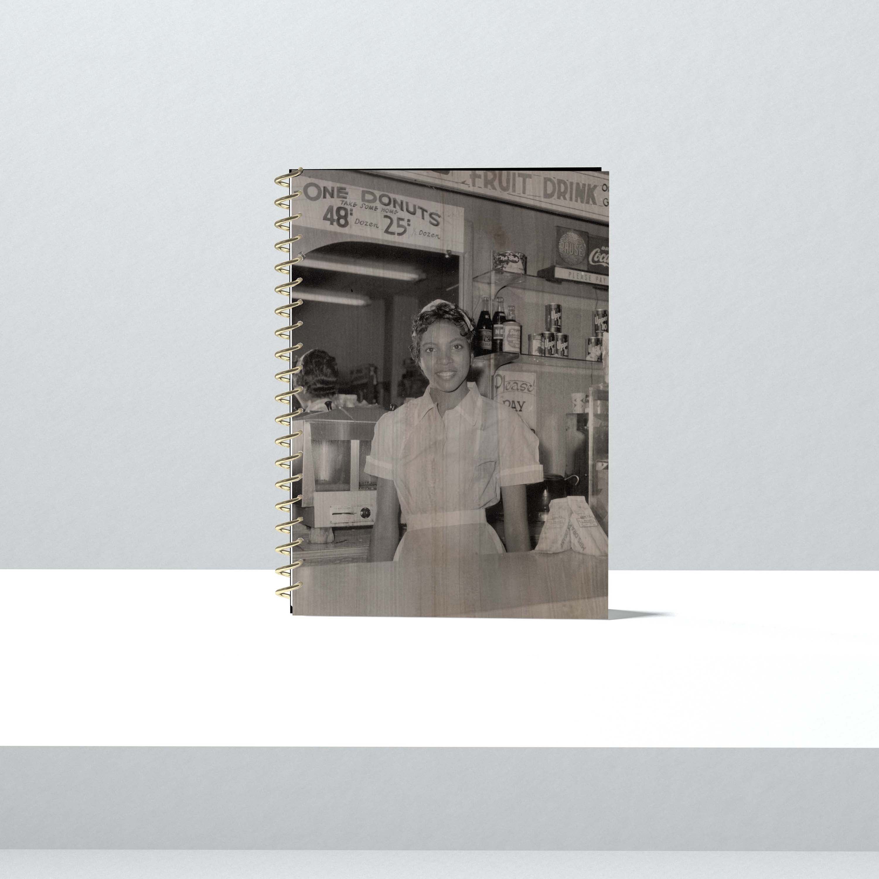 This 1950s photo captures Helen Ann Smith as she poses at the counter of the Harlem House diner, a restaurant chain based ...